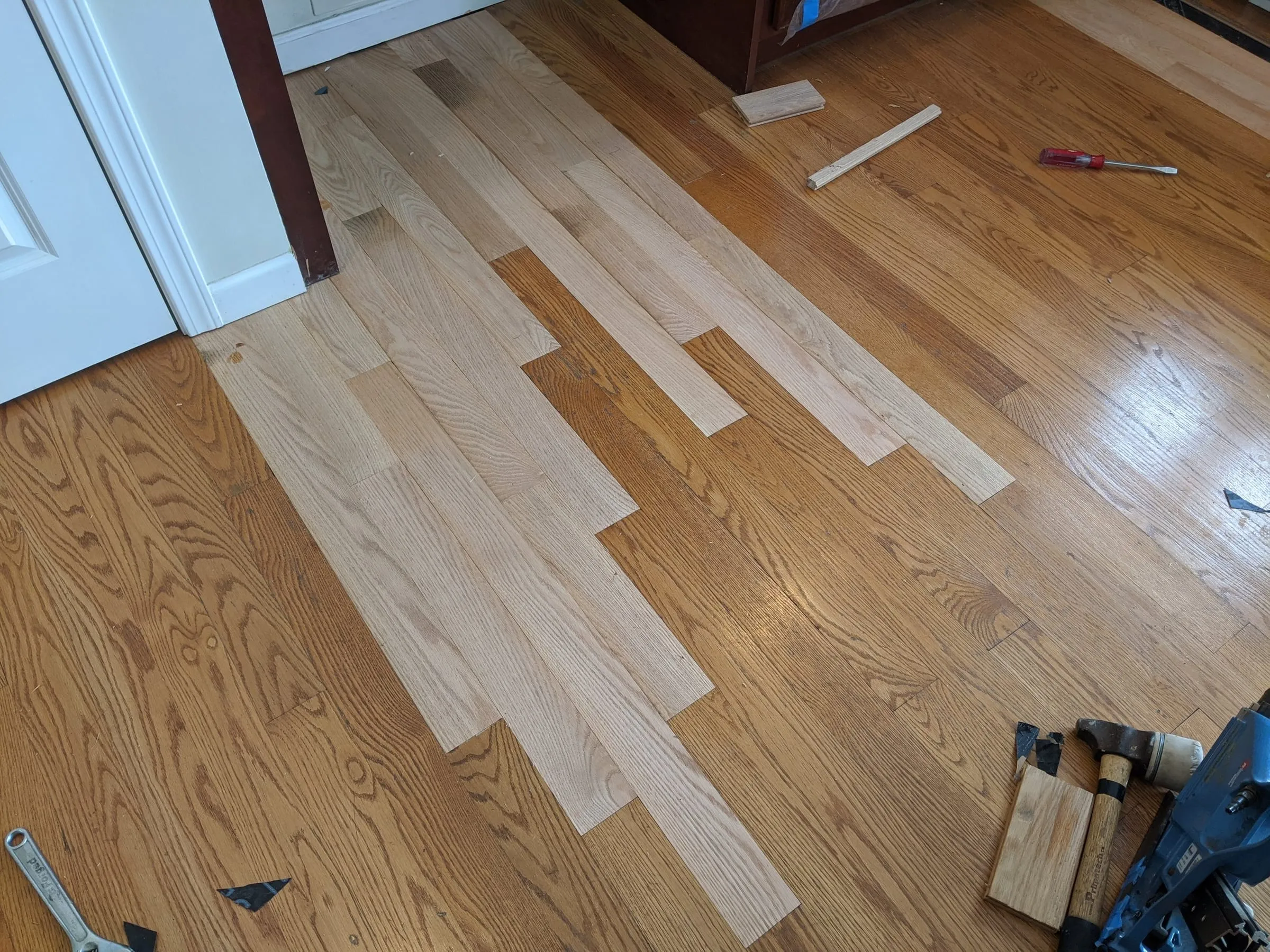New unfinished oak boards woven into an existing finished floor