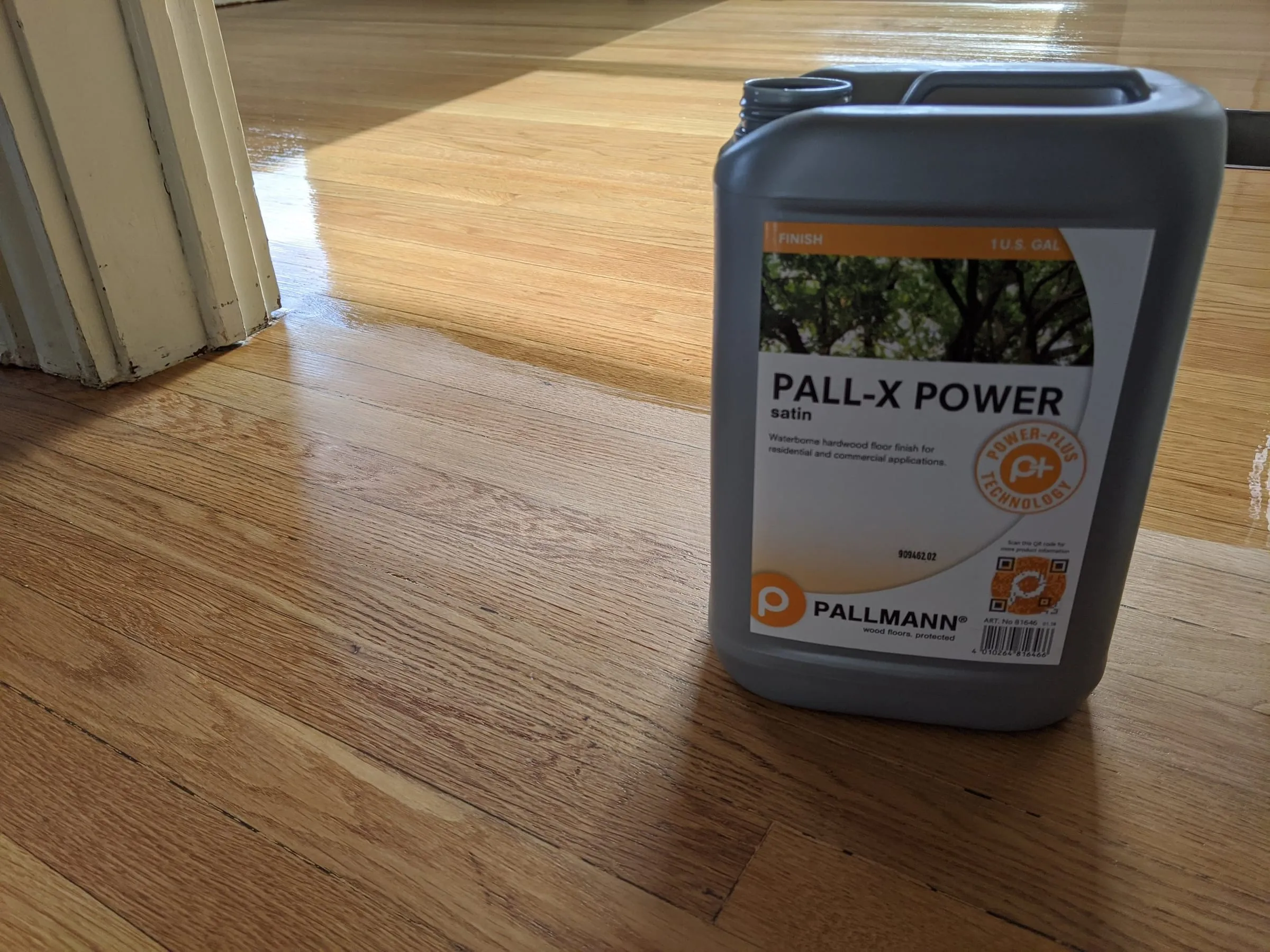 Can of Pallmann Pall-X Power finish on a newly coated oak floor