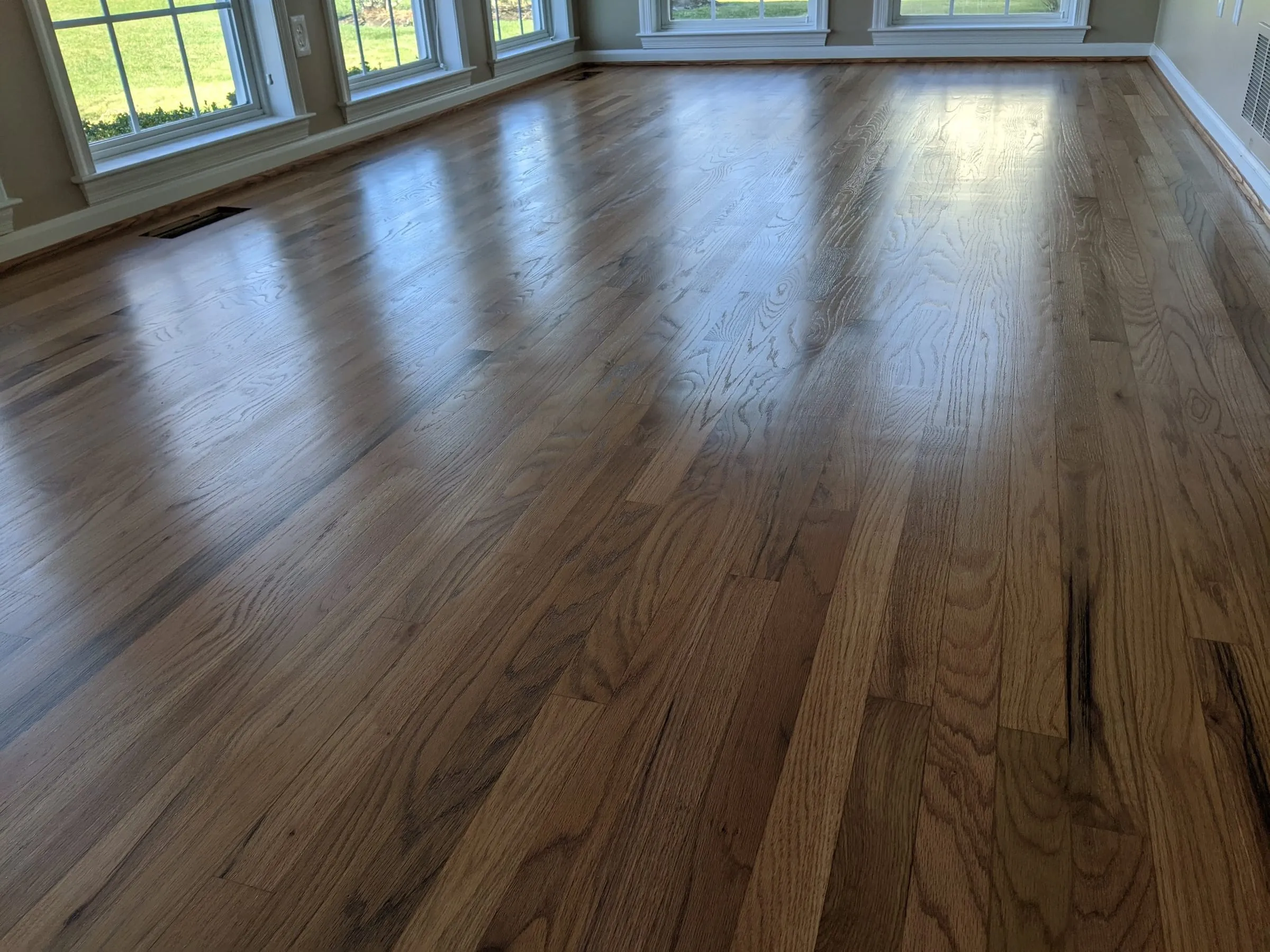 Large bright room with newly refinished honey-oak floors