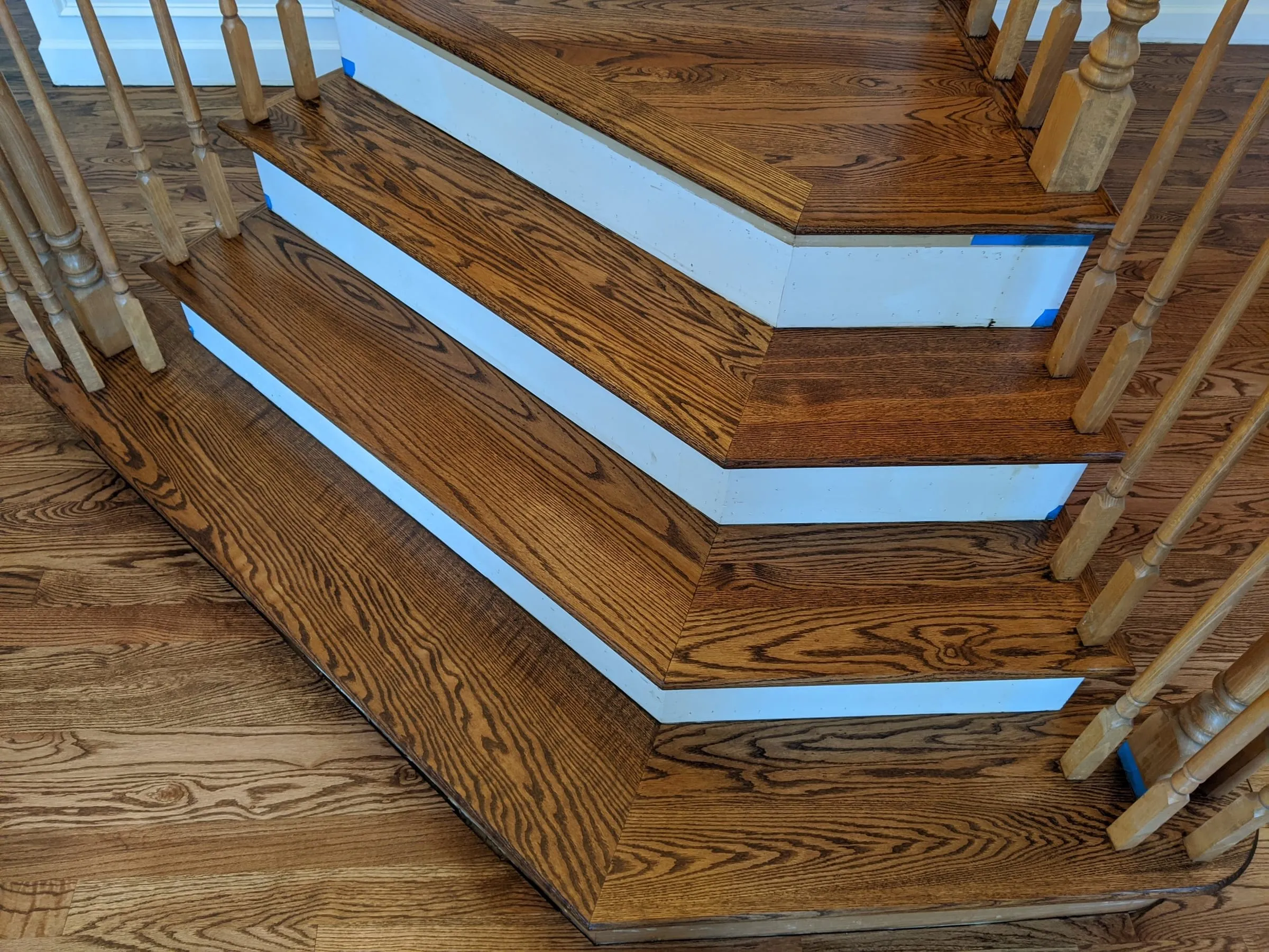 Close-up of stained oak stair treads with white risers