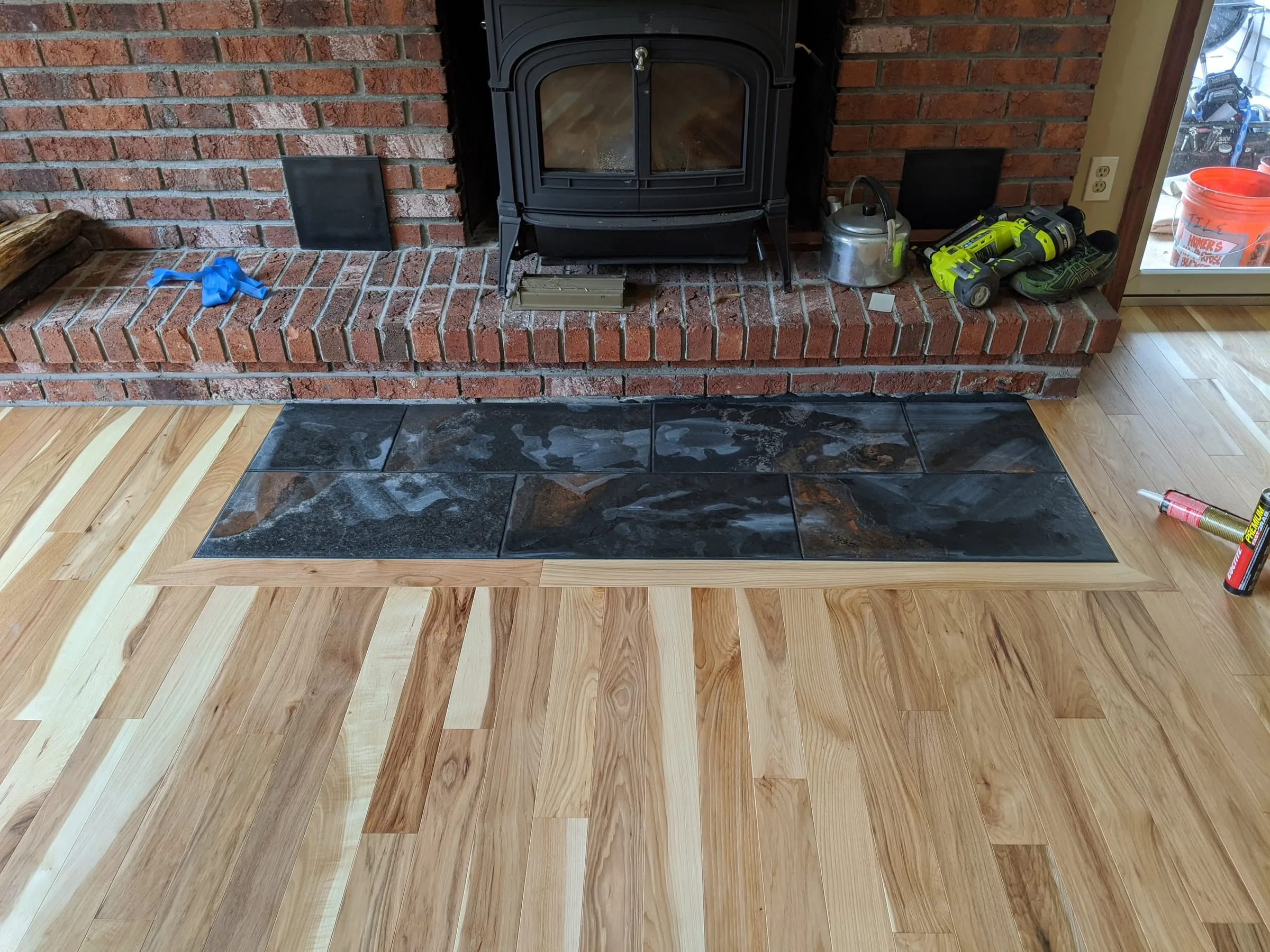 Hickory floor installed around a slate hearth in front of a wood stove